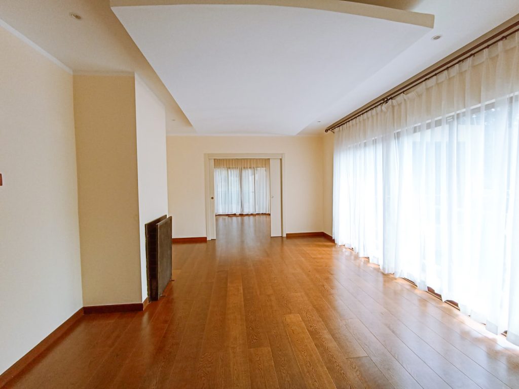 Spacious room with large windows.