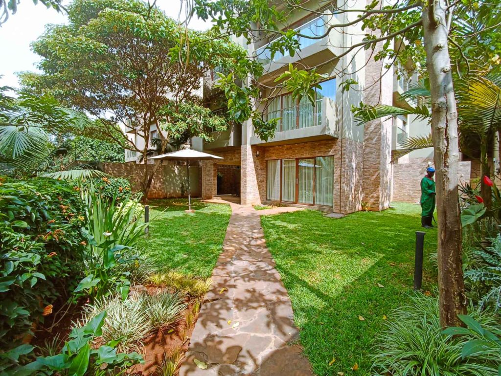 Lush garden surrounding modern building.