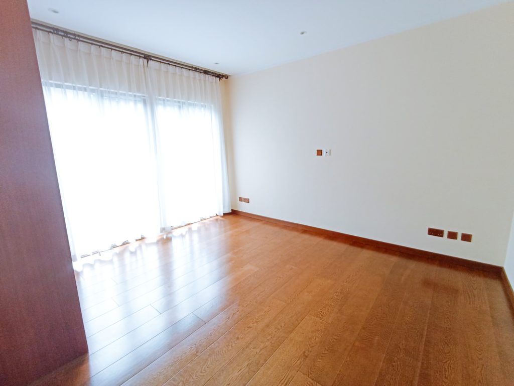 Empty room with wooden flooring.